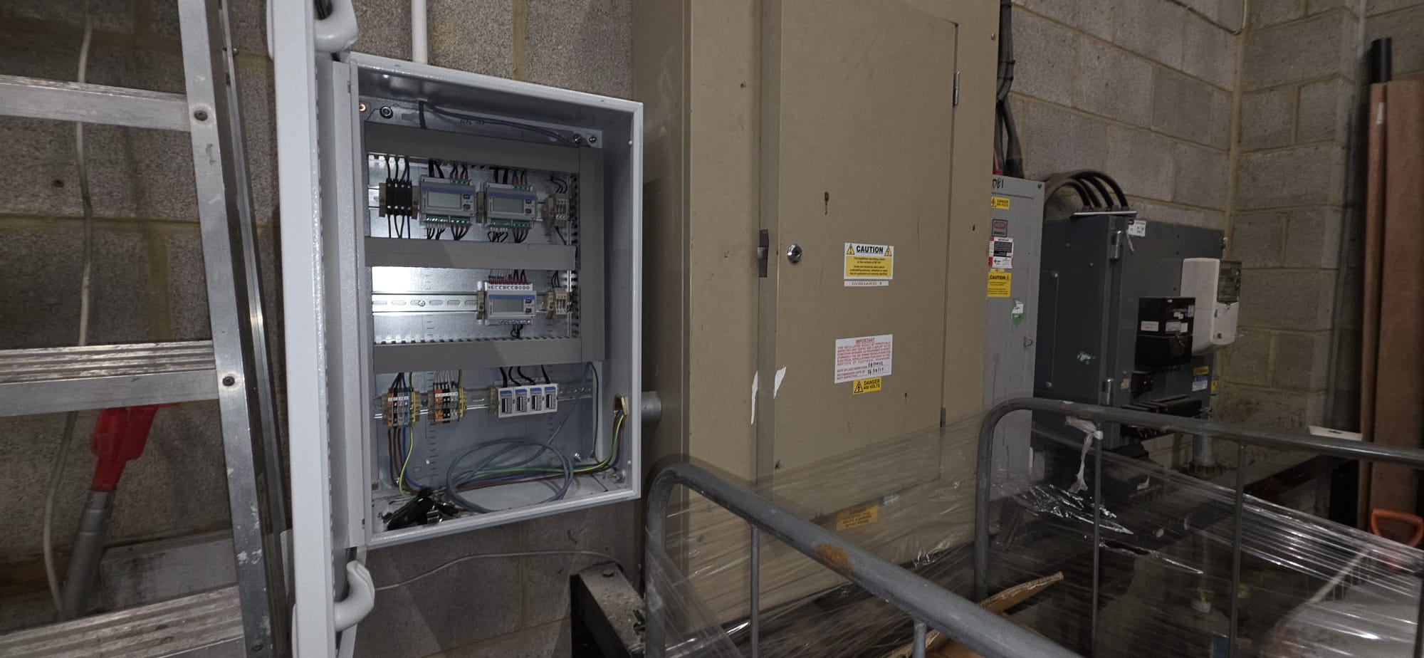 Antler monitoring panel installed beside electrical equipment in a plant room.